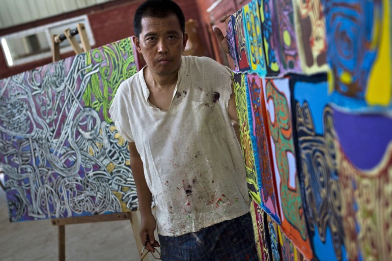 Myanmar artist Htein Lin poses in his studio in Yangon in 2015 [File: Romeo Gacad/AFP]