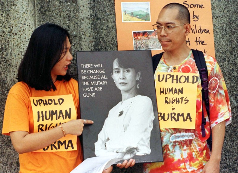 Protesters holding placards about human rights during a rally against Myanmar joining ASEAN in 1997