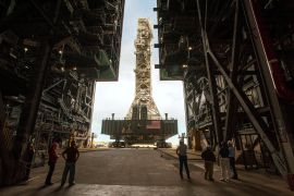 NASA employees look on as the Artemis launch tower rolls back from Pad 39B inside Bay 3 of the Vehicle Assembly Building (VAB) at the Kennedy Space Center in preparation for the landfall of Hurricane Dorian, in Cape Canaveral, Florida, U.S., August 30, 2019.