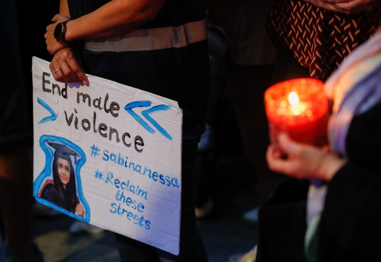 A person holds a placard during a vigil for Sabina Nessa