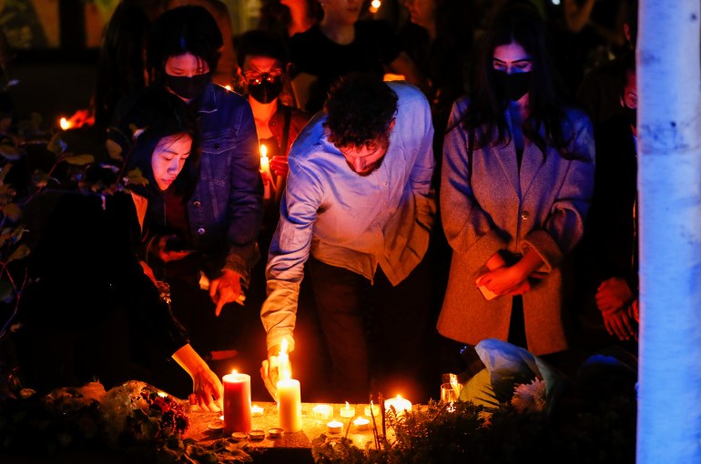 People light candles during a vigil for Sabina Nessa