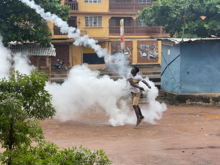 A demonstrator throws a gas canister during an anti-government protest, in Freetown, Sierra Leone.