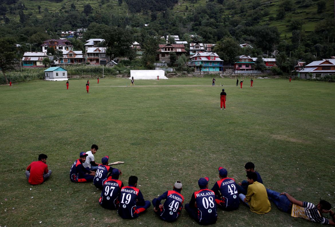 Men play cricket in a playground near the Line of Control between India and Pakistan in Teetwal