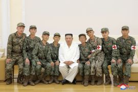 North Korea's leader Kim Jong Un poses for a photo with Korean People's Army medics during a meeting to recognise their contributions in fighting the COVID-19 pandemic in Pyongyang, North Korea