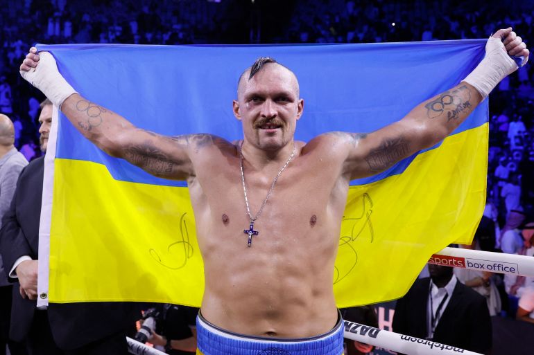 Oleksandr Usyk celebrates winning his fight against Anthony Joshua with the Ukrainian flag