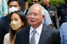 Former Malaysian Prime Minister Najib Razak walks out from the Federal Court during a court break, in Putrajaya, Malaysia