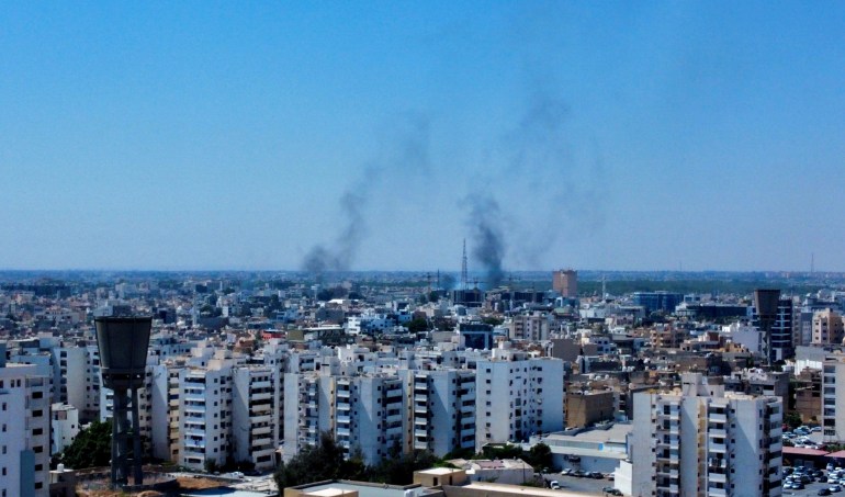 Smoke rises in the sky following clashes in Tripoli, Libya