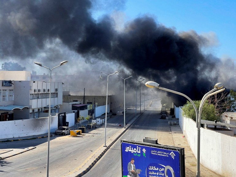Smoke rises in the sky following clashes in Tripoli