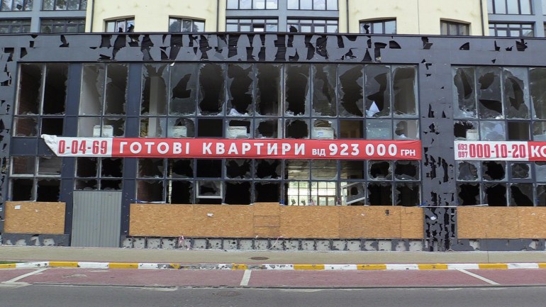 A sign saying 'Complete apartments' on the damaged apartment building in Irpin, Kyiv region