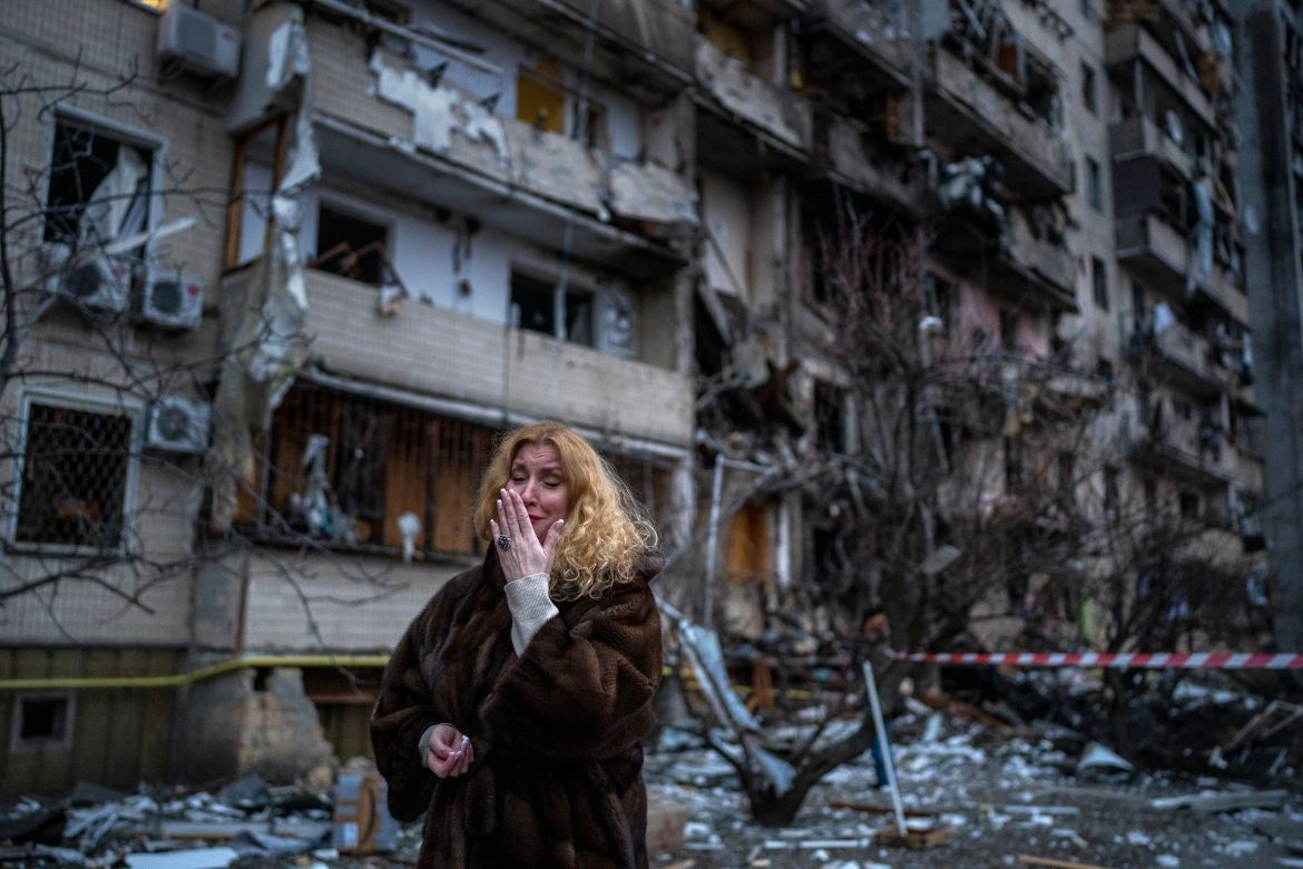 Natali Sevriukova reacts next to her house following a rocket attack the city of Kyiv, Ukraine