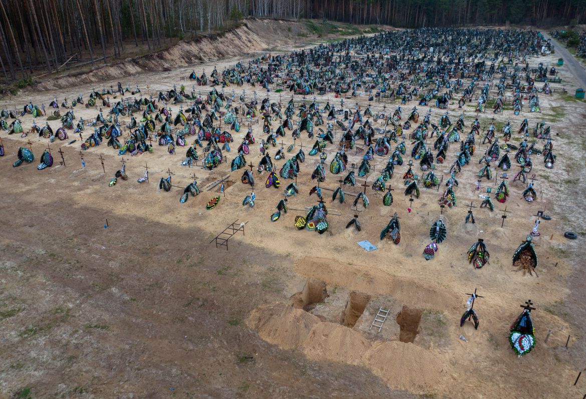 Three dug graves are ready for the next funerals at the cemetery in Irpin, on the outskirts of Kyiv, Ukraine