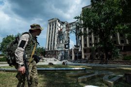 Ukrainian serviceman stands in front of headquarters of the Mykolaiv Regional Military Administration