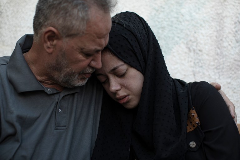 Relatives of Ismail Dweik, who was killed in an Israeli air raid, mourn before his funeral, outside a hospital in Rafah, in the southern Gaza Strip.