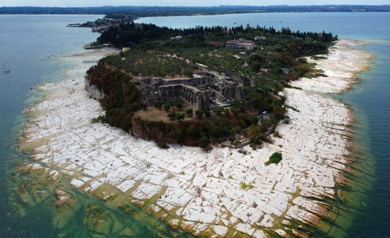 Lake Garda water level has dropped critically following severe drought, resulting in rocks to emerge around the Sirmione Peninsula on August 12, 2022