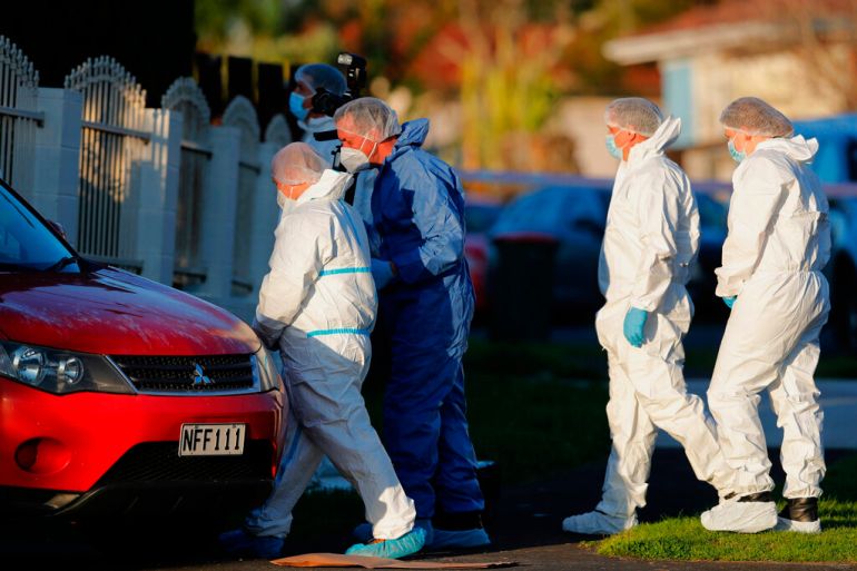 New Zealand police investigators in Auckland on August 11, 2022, after bodies were discovered in suitcases.