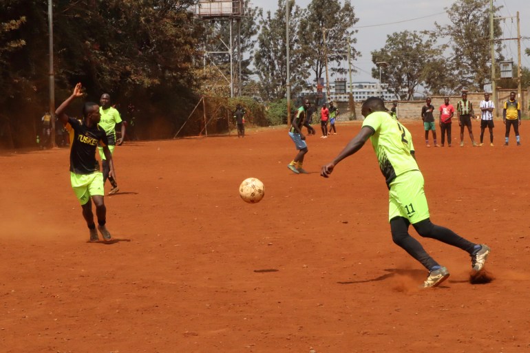 Youths play football at a tournament organised as part of peace efforts ahead of the August 2022 elections