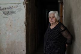 Venera Meshveliani, 86, an internally displaced woman from Akhaldaba, Abkhazia, stands outside the door of her home