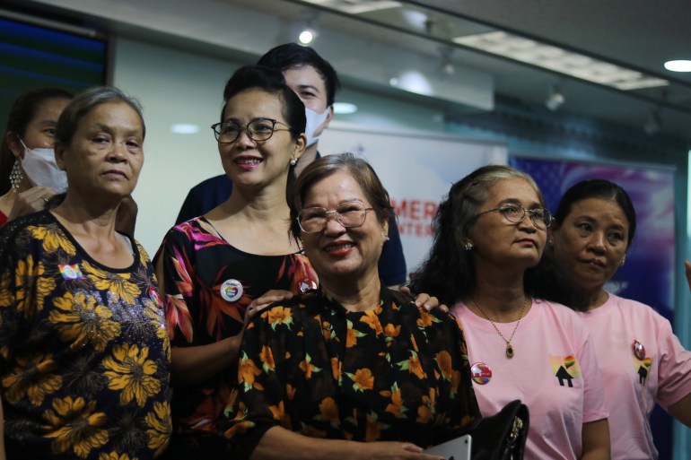 Women smile for a photo at a PFLAG event in Ho Chi Minh City, Vietnam.