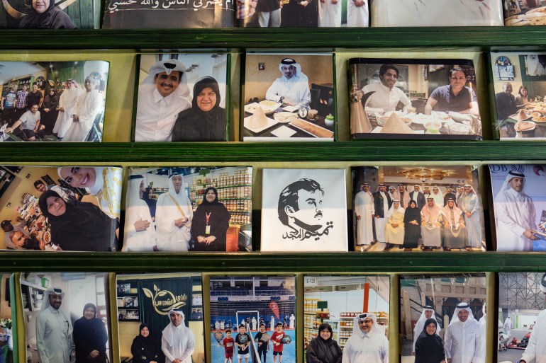 A photos of a wall of photos showing a smiling Shams with a number of peopls who have come to eat at her restaurant or who have honoured her along the way