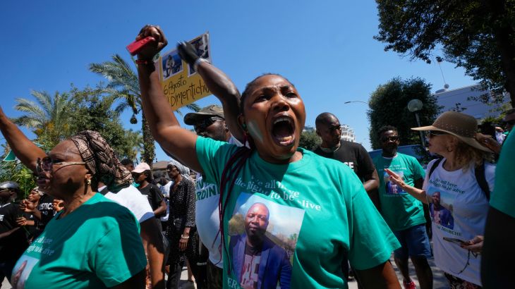 A woman wears a t-shirt with the picture of Nigerian street vendor Alika Ogorchukwu and a writing reading: We all have the right to be alive, during a protest in Civitanova Marche, Italy, Saturday, Aug. 6, 2022.
