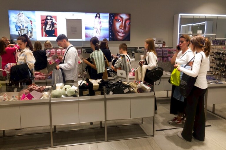 Shoppers buy items on sale in an H&M shop in the shopping mall Aviapark in Moscow, Russia