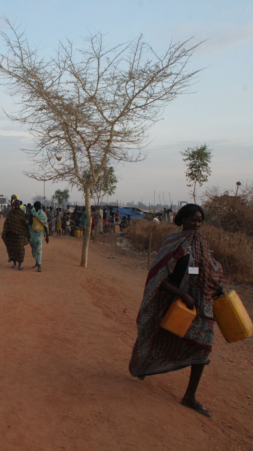 Women walk past a UN tank inside the inside de POC (protection of civilians site) in Malakal, South Sudan, on March 3rd, 2014