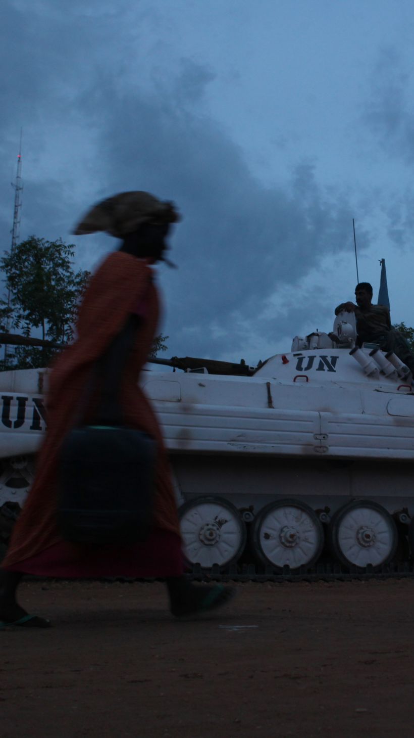Women walk past a UN tank inside the inside de POC (protection of civilians site) in Malakal, South Sudan