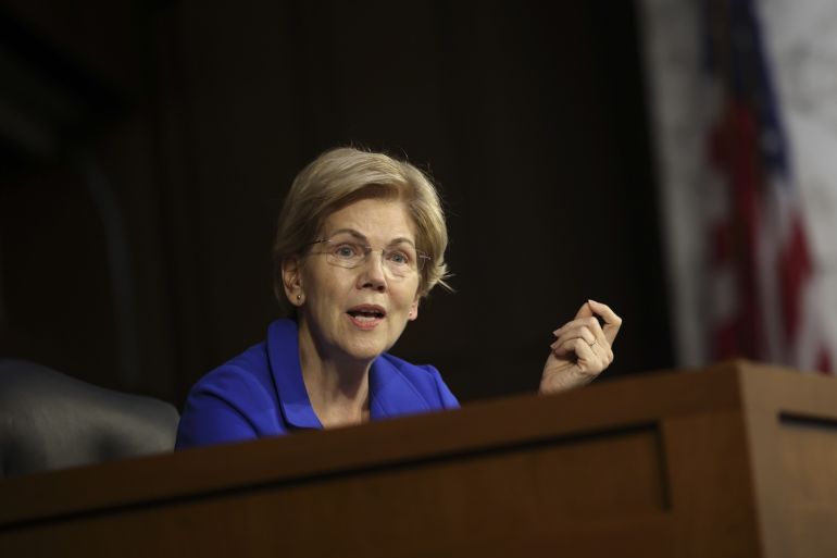 Senator Elizabeth Warren speaking at a lectern.