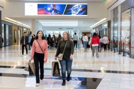 People carrying shopping bags walk inside the King of Prussia shopping mall, as shoppers show up early for the Black Friday sales, in King of Prussia, Pennsylvania, U.S.