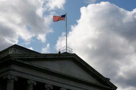 The United States flag flies atop the US Treasury Department in Washington, DC.