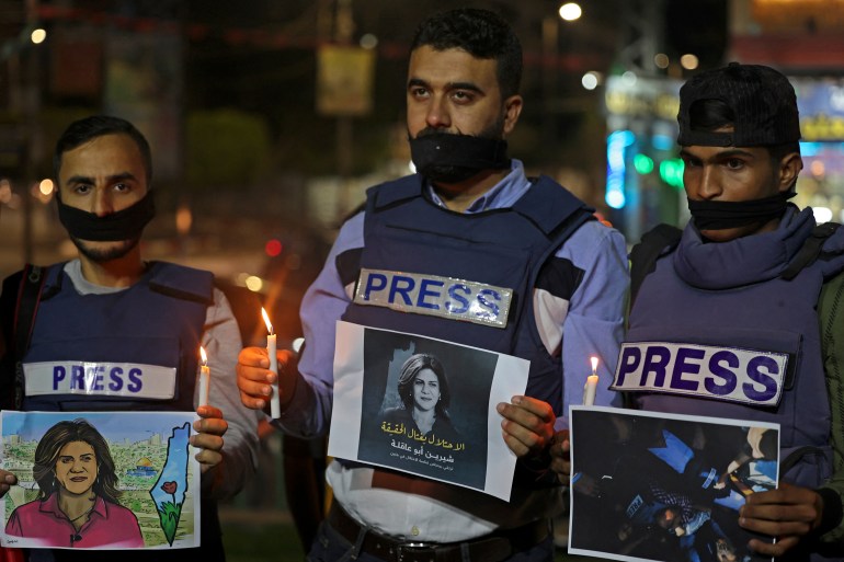 Journalists take part in a candlelight vigil to condemn the killing of veteran Al-Jazeera journalist Shireen Abu Akleh in Rafah in the southern Gaza Strip on May 11, 2022.