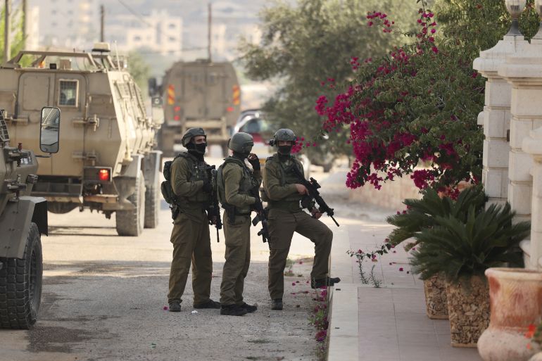Israeli soldiers keep position during a military operation in the Palestinian town of Silwad, near the city of Ramallah in the occupied West Bank, on August 31, 2022.