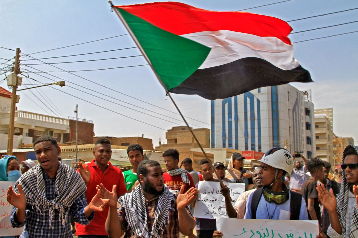 Sudan protesters waving flag