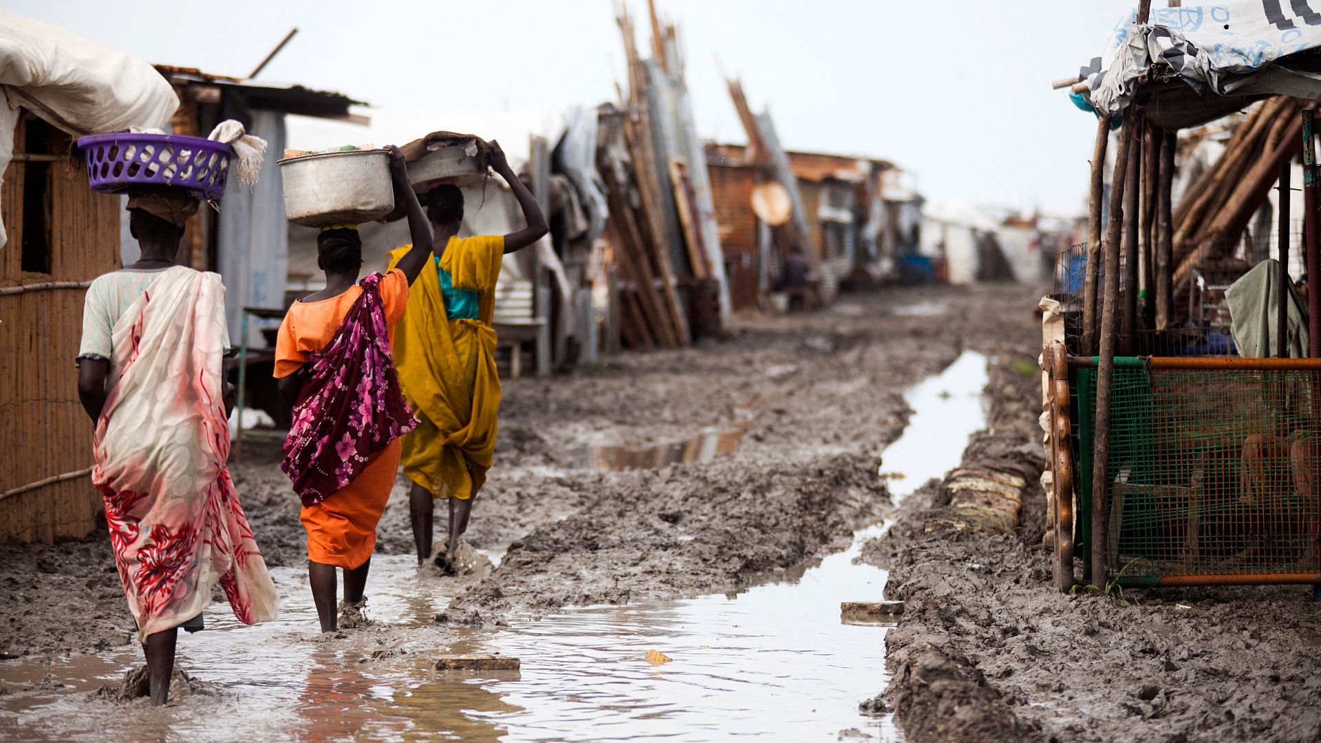 Women carry their belongings inside the Protection of Civilians (PoC) site in Malakal, on June 14, 2016