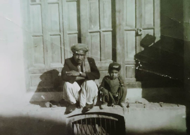 A photo of a man sitting next to a child.