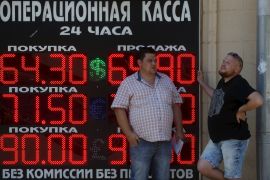 Men stand next to a board showing currency exchange rates of the U.S. dollar, euro, and British pound (top-bottom) against the rouble in Moscow, Russia, August 12, 2015. The Russian rouble hit a six-month low on Wednesday, tracking down lower oil prices and ignoring a central bank statement saying that the devaluation of the Chinese yuan may ultimately benefit the rouble. REUTERS/Sergei Karpukhin