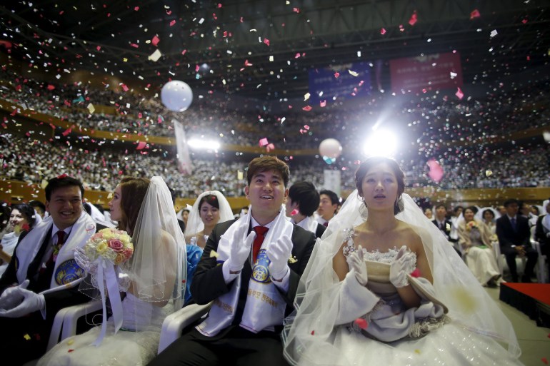 Yoo Jung-seuk of South Korea and Tasaka Yumi of Japan celebrate during a mass wedding ceremony of the Unification Church at Cheongshim Peace World Centre in Gapyeong, South Korea, February 20, 2016.