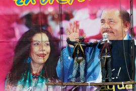 Workers put up a billboard of Nicaragua VP Rosario Murillo and President Daniel Ortega