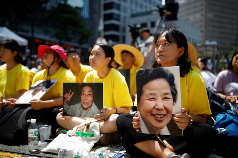 Students hold portraits of deceased former South Korean "comfort women" during a weekly anti-Japan rally in Seoul, South Korea, August 15, 2018. 