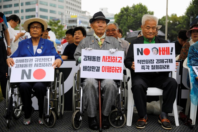 Lee Choon-shik, a victim of wartime forced labor during the Japanese colonial period, holds a banner that reads "Apologize for forced labour and fulfill the compensation" during an anti-Japan protest on Liberation Day in Seoul, South Korea, August 15, 2019. 