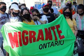 Migrants, refugees, undocumented workers and their supporters rally in Toronto, Canada