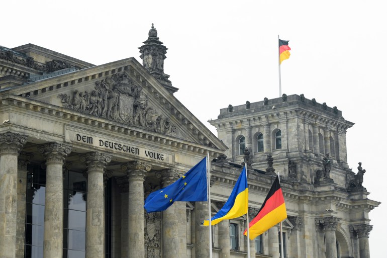 The EU, Ukraine and Germany's flags wave outside the Reichstag building