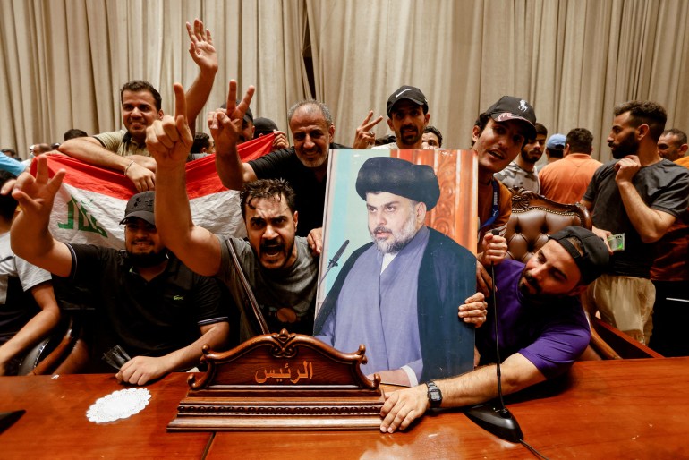 FILE PHOTO: Supporters of Iraqi Shi'ite cleric Moqtada al-Sadr react as they protest against corruption inside the parliament building in Baghdad, Iraq July 27, 2022.