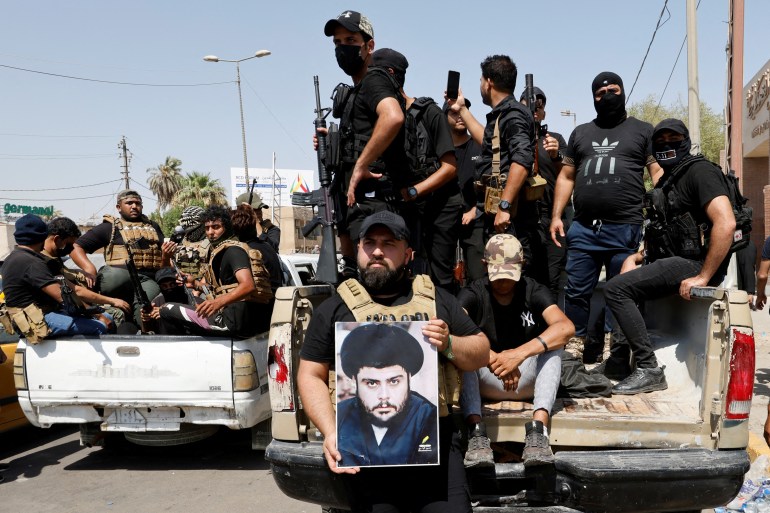 Followers of Iraqi cleric Moqtada al-Sadr withdraw from the streets after violent clashes, near the Green Zone in Baghdad, Iraq, August 30, 2022.
