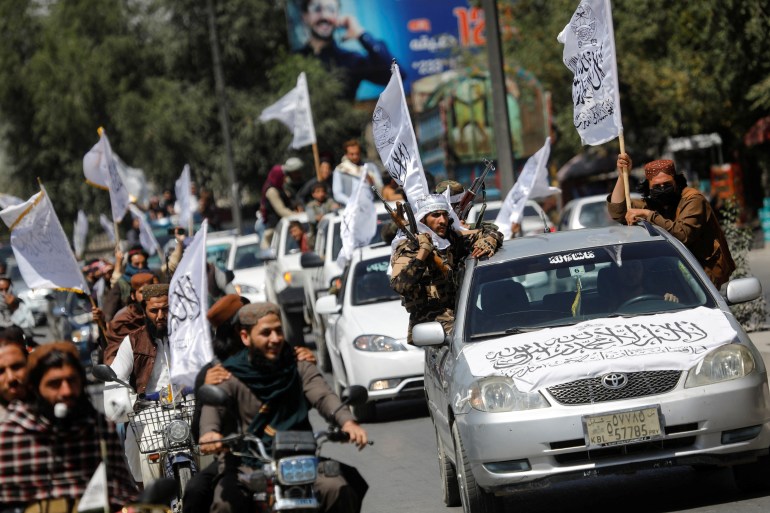 Taliban members drive in a convoy to celebrate the first anniversary of the withdrawal of U.S. troops from Afghanistan, along a street in Kabul, Afghanistan, August 31, 2022.