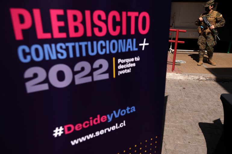 A soldier stands guard inside a school used as a trial vote polling station ahead of the September 4th constitutional referendum in Santiago, Chile September 2, 2022. The sign reads 'Constitutional Referendum 2022'. REUTERS/Ivan Alvarado