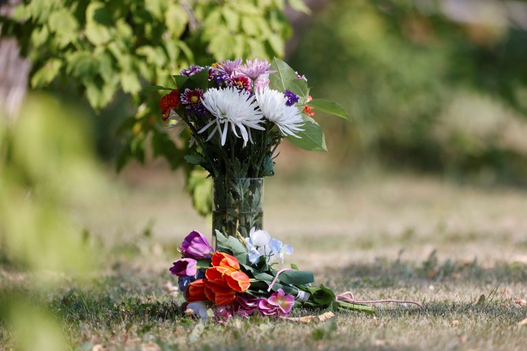 Flowers stand outside a house linked to the stabbing spree in Canada's Saskatchewan this month