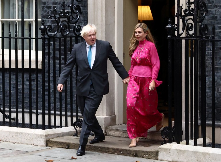 Outgoing British Prime Minister Boris Johnson, with his wife Carrie Johnson, arrives to deliver a speech on his last day in office