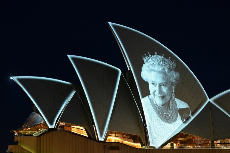 An image of Britain's Queen Elizabeth is illuminated on the sail of Sydney Opera House