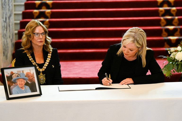 First Minister designate Sinn Fein's Michelle O'Neill signs the book of condolences at the City Hall, in Belfast, Northern Ireland